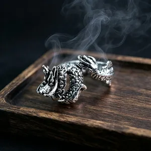 Macro detail of retro silver dragon ring with intricate scale relief and dragon head design