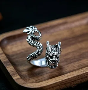 Macro detail of retro silver dragon ring showing intricate scales and dragon head design