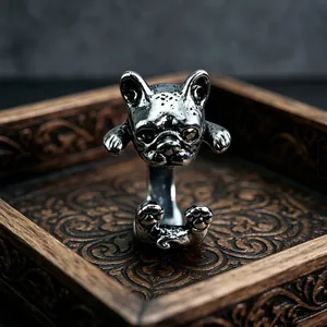 Macro detail of retro silver bulldog ring showing intricate animal carving and texture