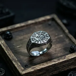 Macro shot of retro Yin Yang octagon ring with Tai Chi Ba Gua symbols in silver finish