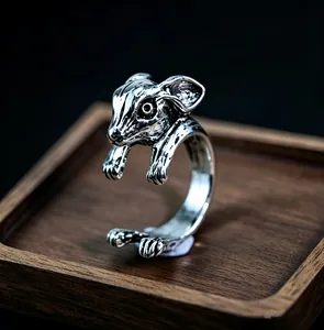 Detailed relief of a vintage silver animal ring showing textured fur and embossed patterns