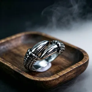 Detailed close-up of retro silver dragon claw ring with intricate scale textures