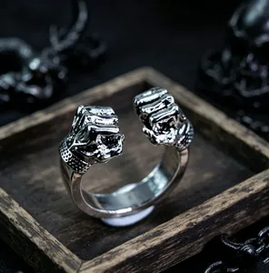 Detail shot of vintage silver double-fist open ring with punk rock textured aesthetic