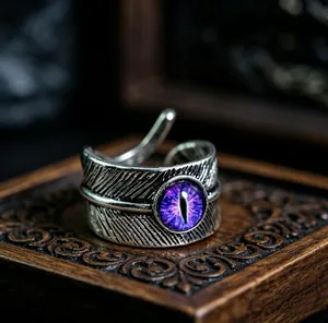 Macro detail of retro feather textured ring with purple cat eye stone on wood