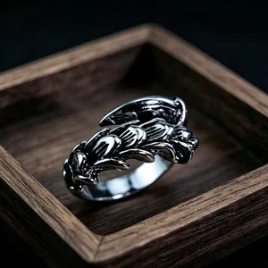 Macro shot of vintage silver metal ring featuring overlapping gothic feather design details