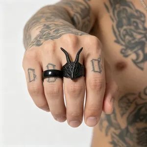 Detail of men's black goat skull and minimalist ring on tattooed hand