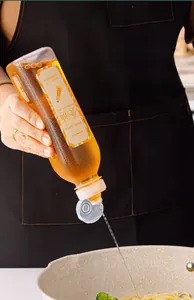 Close-up of leakproof squeeze oil dispenser pouring cooking oil into a frying pan