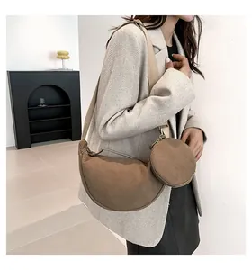 Detail of coffee brown corduroy crescent bag with matching round coin purse on strap