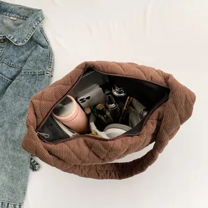 Brown quilted corduroy tote bag with large capacity showing items for daily use