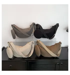 Detail view of corduroy half-moon bags in four colors with matching round coin purses