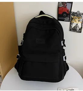 Detail of black nylon backpack featuring HAOHU logo and contrast buckle on a desk