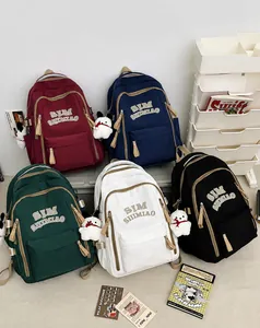 Detailed view of canvas backpacks in red, blue, green, white, and black colors