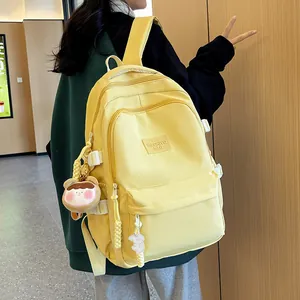 Minimalist large yellow school backpack with multi-layer zippers and a cute bear charm
