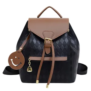 Quilted black drawstring bucket backpack with brown leather trim and golden buckle detail