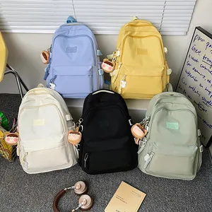 Minimalist nylon school backpacks in five colors with cute plush charms for students