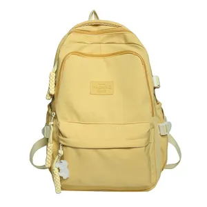 Minimalist bright yellow nylon school backpack for students with a cute bunny keychain