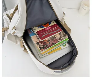 Interior view showing the large capacity of the beige canvas backpack for books