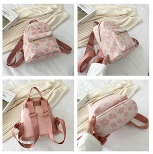 Stylish light pink floral mini backpack for women with adjustable straps and gold zippers