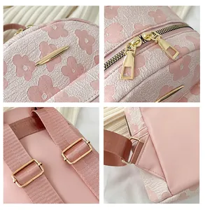 Detail view of pink floral jacquard texture and golden zipper hardware on women backpack