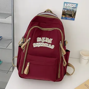 Minimalist burgundy nylon backpack with large capacity and letter embroidery for students