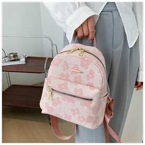Pink floral jacquard mini backpack with white flower pattern and gold metal zippers
