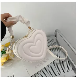 Chic white heart-shaped crossbody bag with ruffled handle and 3D pleated design