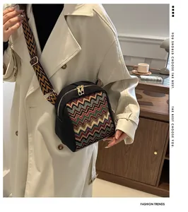 Close-up of ethnic style crossbody bag with colorful zigzag patterns and wide jacquard strap