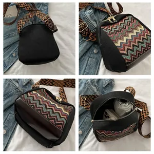 Detail of ethnic style crossbody bag featuring wave patterns and wide geometric strap