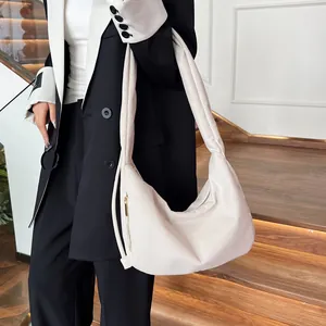 Detail of off-white corduroy hobo bag with drawstring pleats and metal zipper