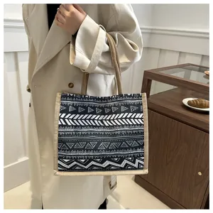 Detail of bohemian tote bag with black and white geometric ethnic prints and jute handles