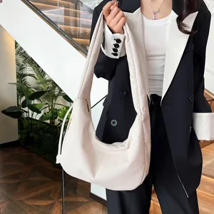 Close-up of off-white corduroy shoulder bag with clear ribbed texture and wide strap