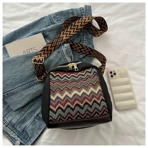 Detail of the multi-colored wave pattern on this ethnic crossbody bag with leather base
