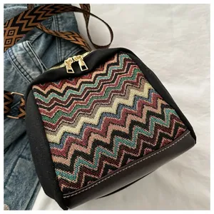 Close-up of ethnic multi-color wave patterned bag with premium gold metal zippers