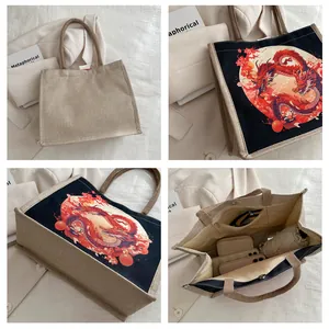 Detail view of canvas tote bag with red dragon print, interior pocket, and brown handles