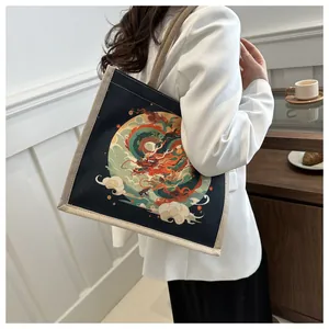 Detail of canvas tote bag featuring an artistic colorful Chinese dragon print on black fabric