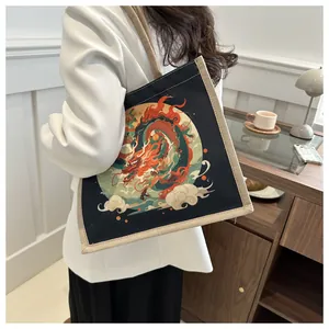 Detailed close-up of a black canvas tote with a colorful traditional Chinese dragon print