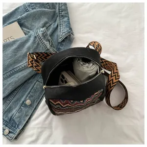 Ethnic style black canvas bag interior showing space for a phone and a folding umbrella