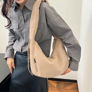 Detailed macro view of the beige corduroy shoulder bag showing zipper and ribbed texture