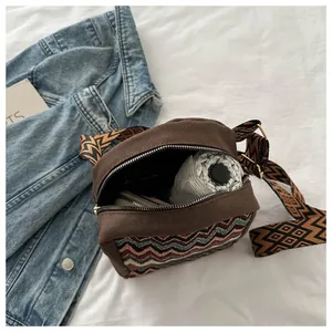 Interior view of brown canvas crossbody bag with wave patterns showing large capacity