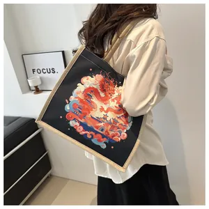 Detail view of the canvas tote bag featuring dragon print and woven texture contrast