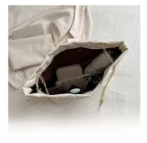 Interior view of quilted tote bag showing space for phone, wallet and cosmetics