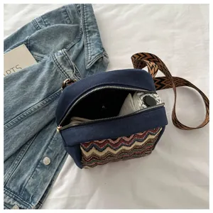 Detail view of ethnic canvas crossbody bag interior showing daily storage space for umbrella