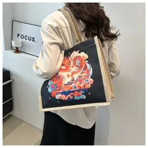 Detail view of ethnic style black tote bag featuring dragon and auspicious clouds illustration