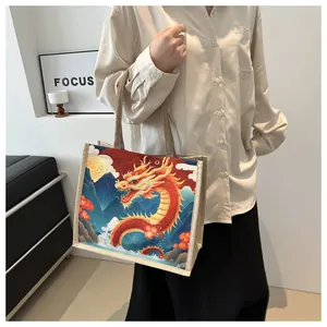 Close-up of canvas tote bag featuring vibrant dragon print and woven handles