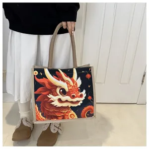 Detailed view of canvas tote bag featuring traditional Chinese dragon print with woven handle