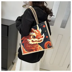 Close-up of a sturdy canvas tote bag featuring a vibrant red cartoon dragon print
