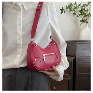 Detail of rose pink dumpling bag with silver rivets and retro pleated texture