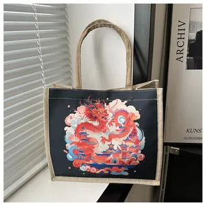 Detail of canvas tote bag featuring artistic red dragon print and woven jute texture