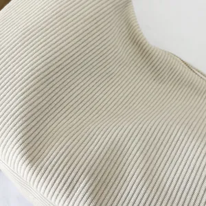 Detailed close-up of premium beige corduroy fabric texture and smooth metal zipper