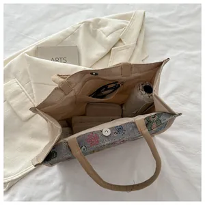 Vue intérieure du sac cabas spacieux en toile avec poches pratiques et broderie cartoon